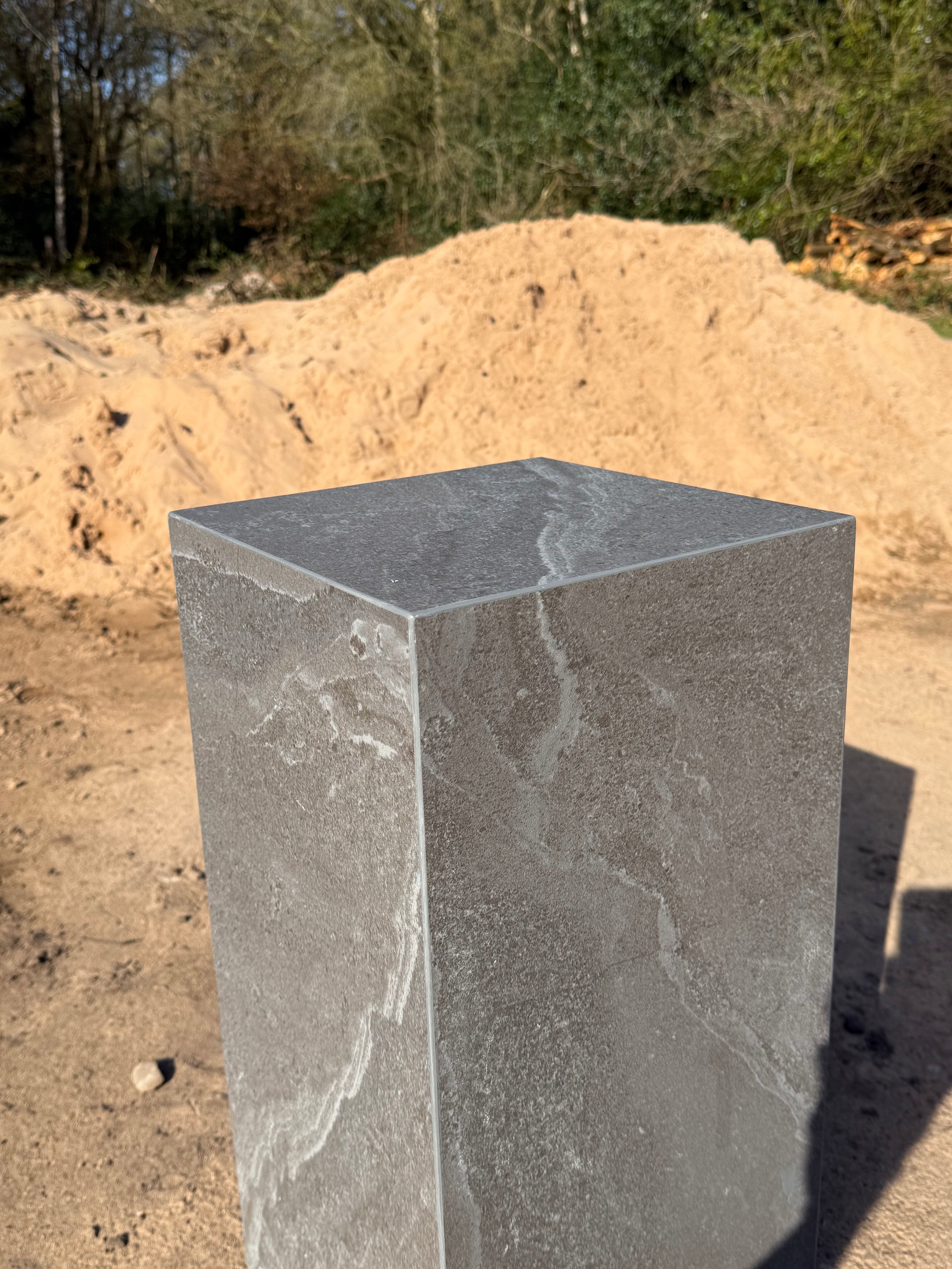Close-up of dark grey matte porcelain tile finish and hand-mitred corner