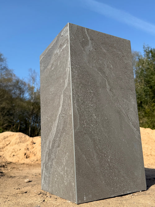 Side view of dark grey matte porcelain side table showing mitred corner detail