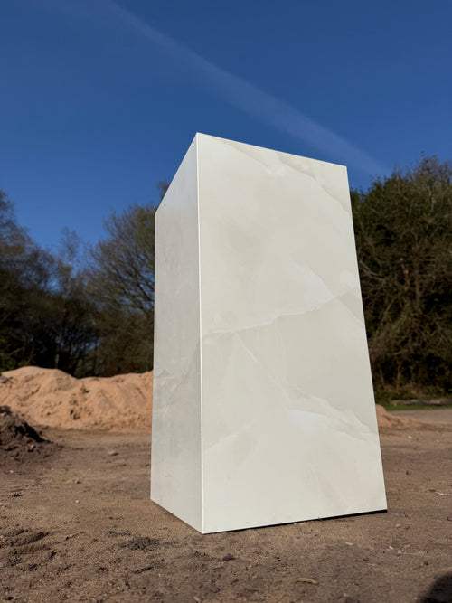Close-up of white marble-effect polished porcelain tile finish and hand-mitred corner